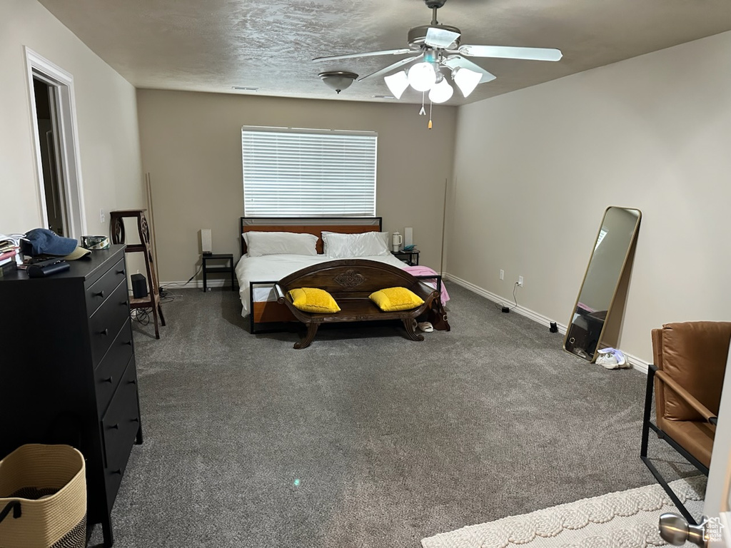 Bedroom featuring baseboards, carpet flooring, and a ceiling fan