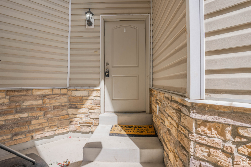 View of exterior entry featuring stone siding