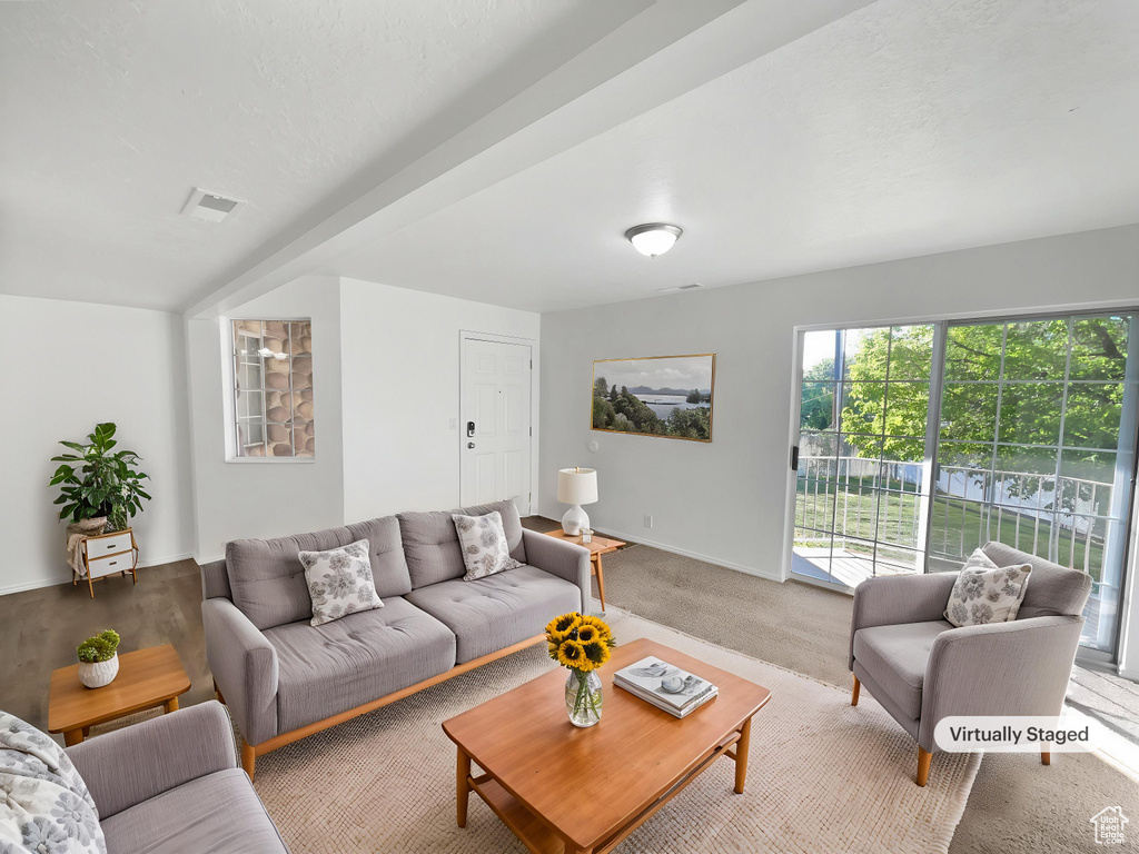 Living room featuring baseboards, light carpet, visible vents, and plenty of natural light