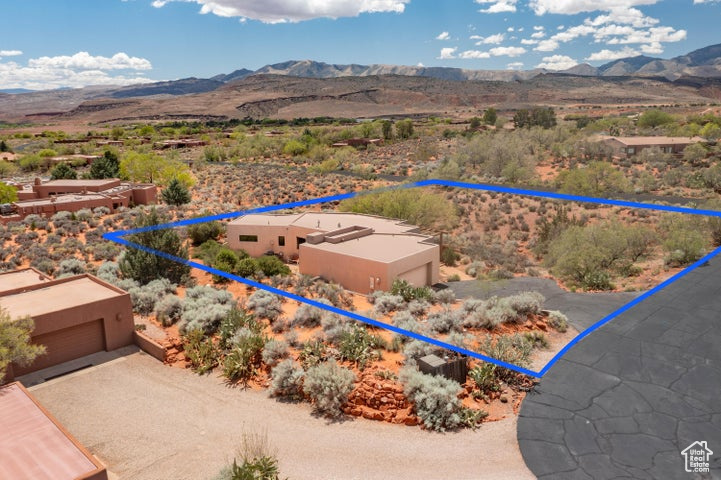 Drone / aerial view featuring view of desert and a mountain view
