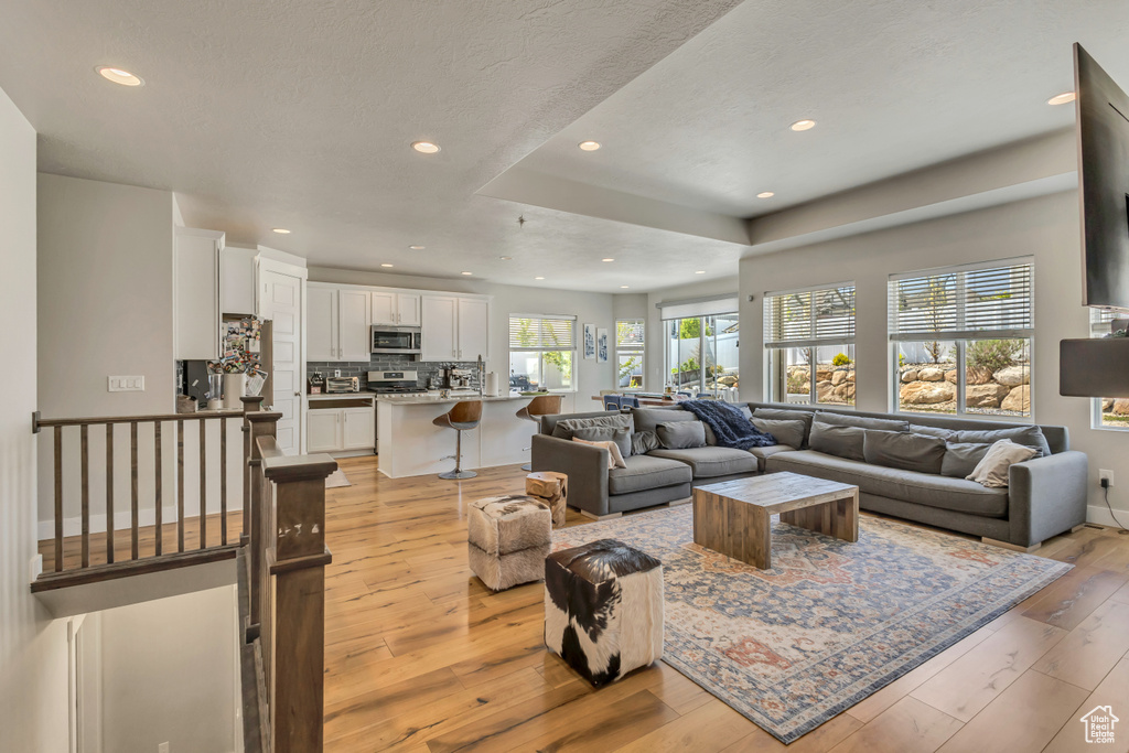 Living room featuring light wood-style floors and recessed lighting