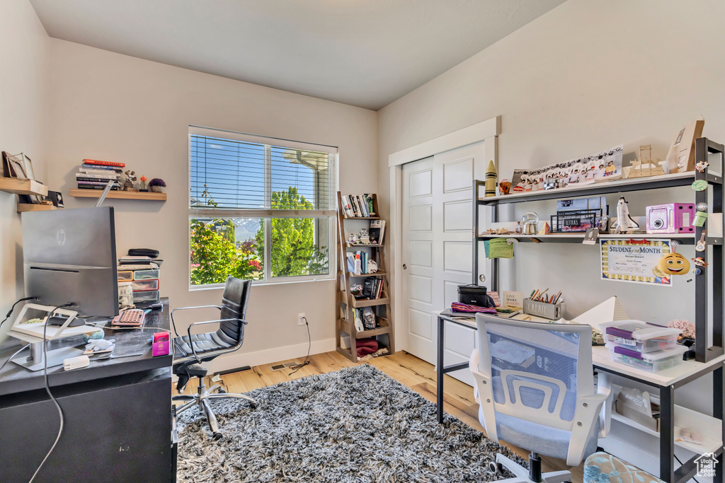 Office area featuring baseboards and wood finished floors