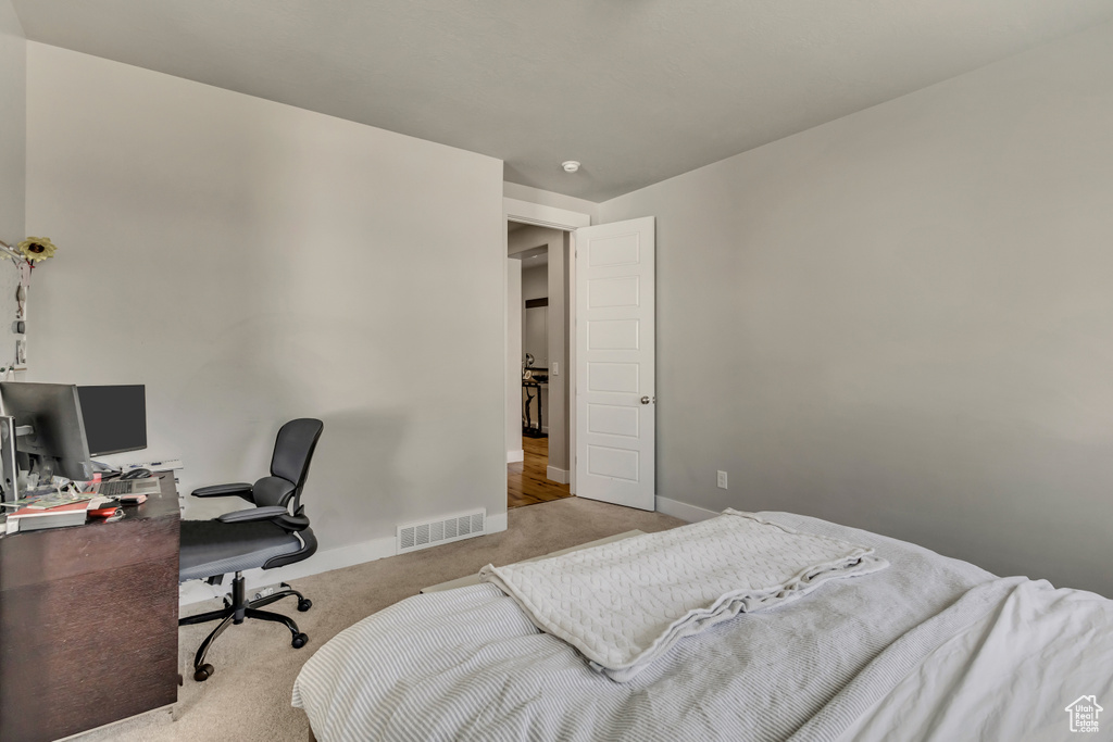 Bedroom featuring baseboards, visible vents, and carpet floors
