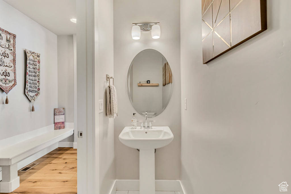 Bathroom featuring baseboards and wood finished floors
