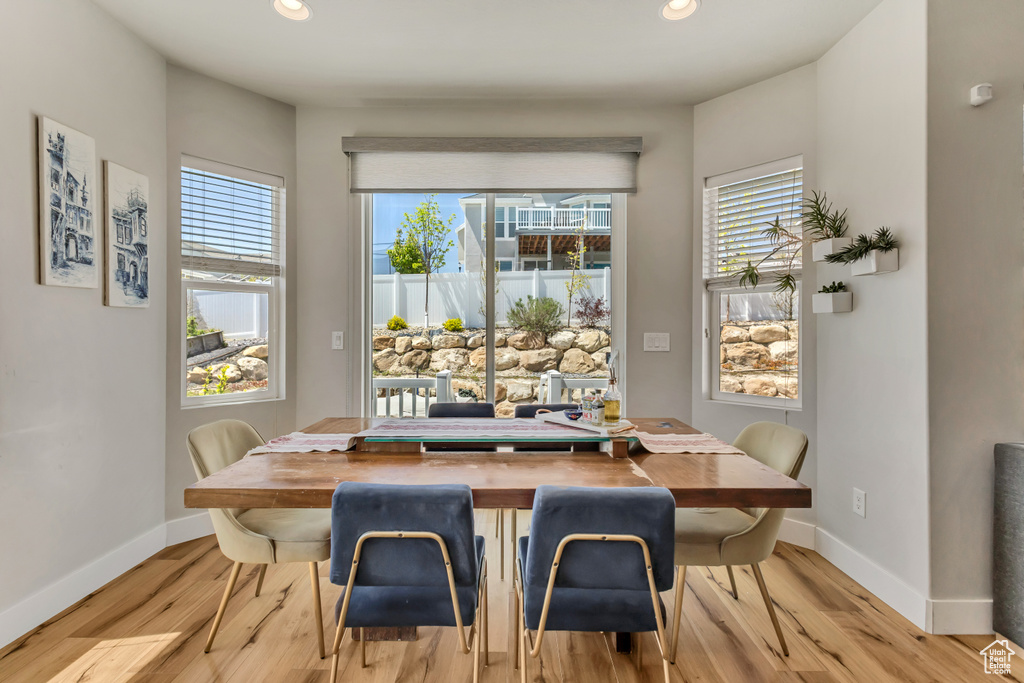 Dining room featuring baseboards, light wood-type flooring, and recessed lighting