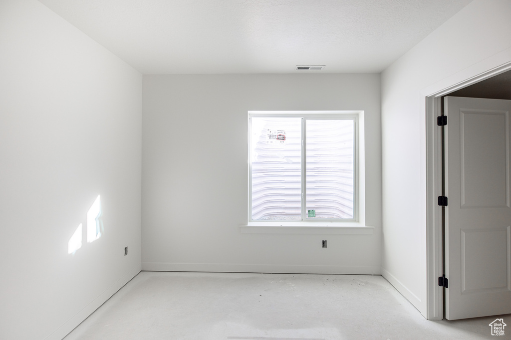 Empty room with baseboards, a healthy amount of sunlight, and visible vents