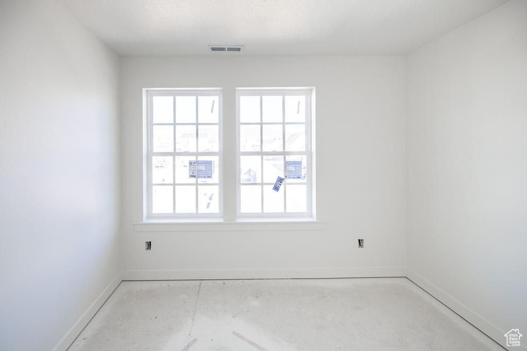 Empty room featuring plenty of natural light, baseboards, and visible vents