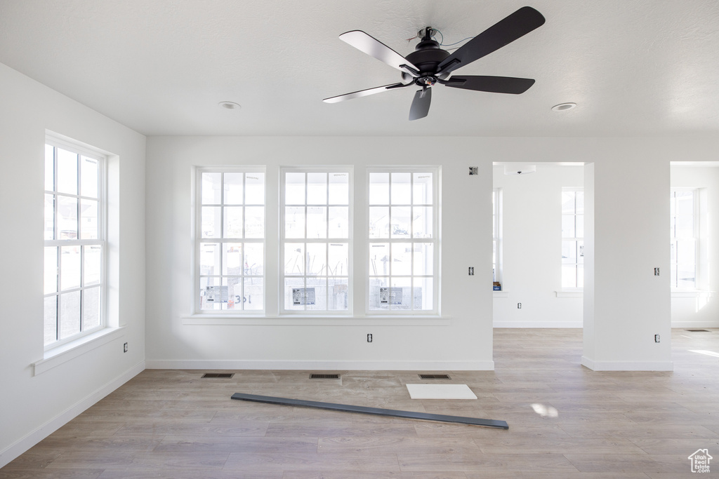 Interior space featuring baseboards, a wealth of natural light, and visible vents