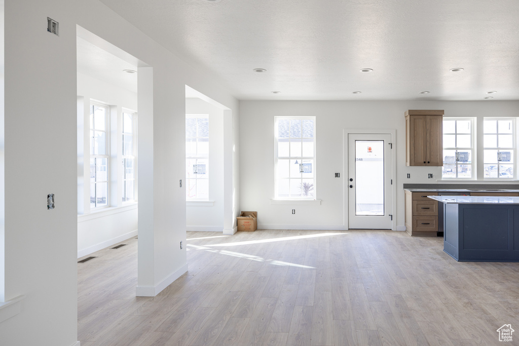 Unfurnished living room featuring baseboards, recessed lighting, visible vents, and light wood-type flooring