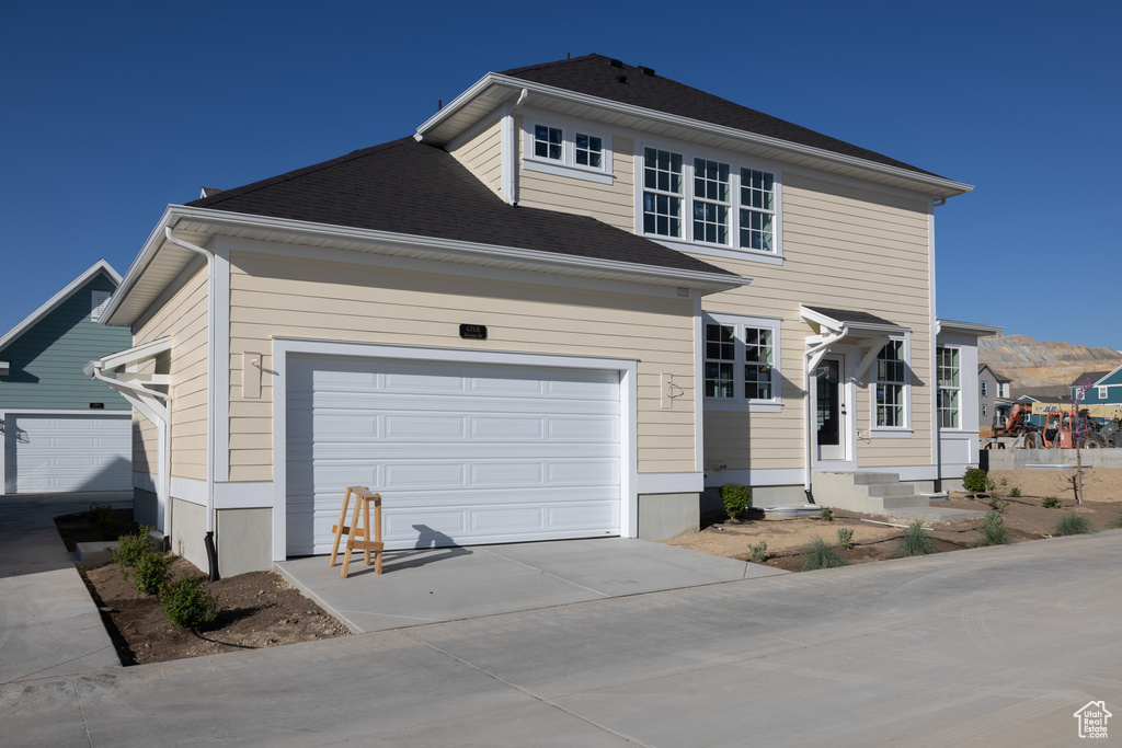 Traditional-style house with an attached garage and driveway