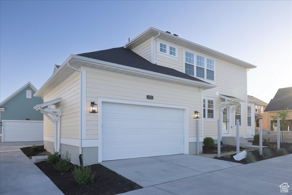 View of front of house with a garage and concrete driveway