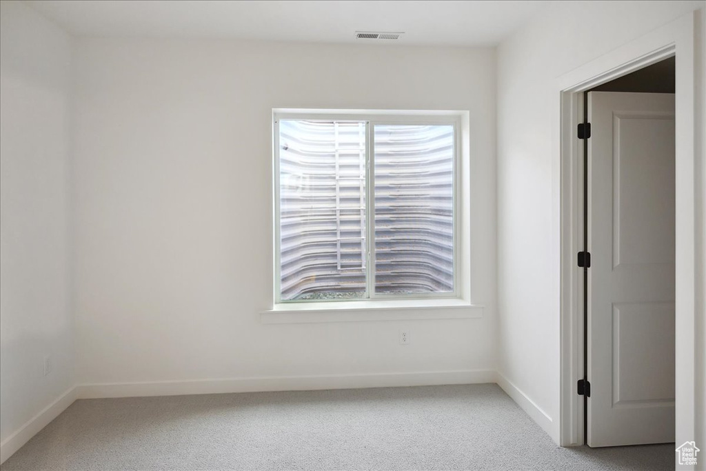 Unfurnished room featuring carpet and baseboards
