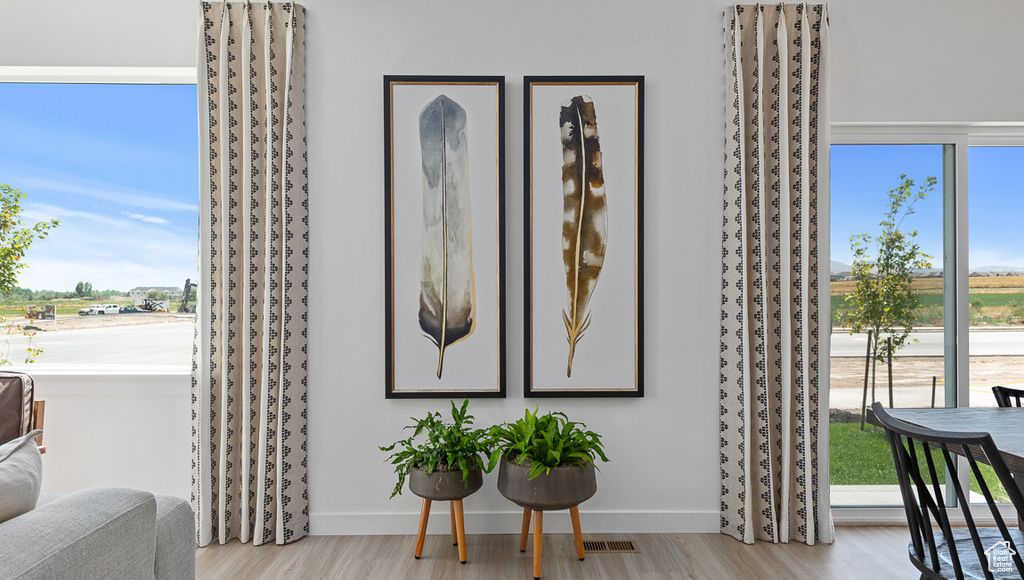 Details with baseboards, visible vents, and wood finished floors