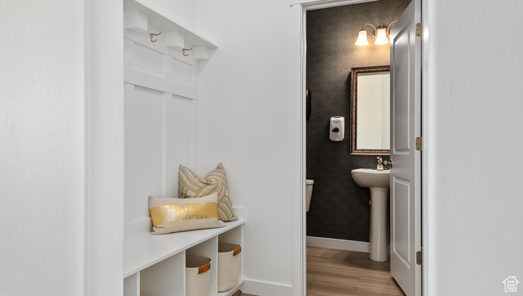 Mudroom featuring baseboards and wood finished floors