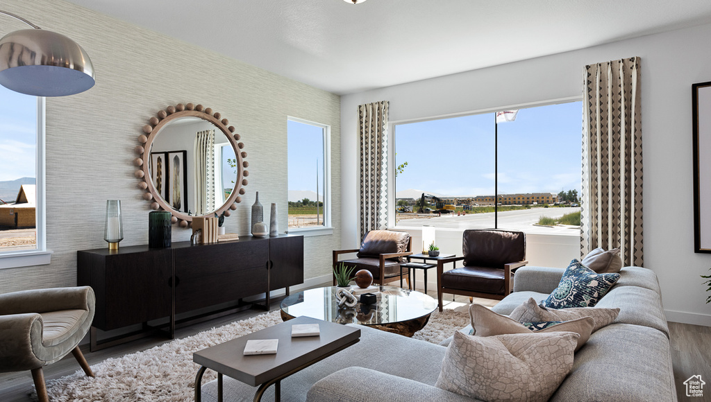 Living area with wood finished floors and baseboards