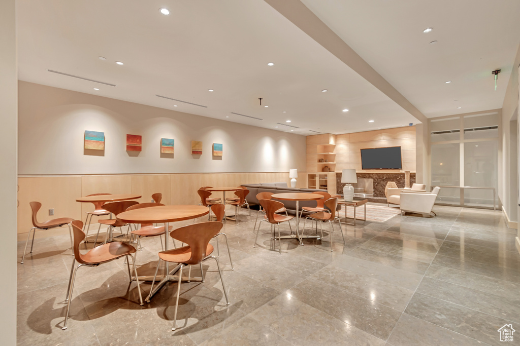 Dining space featuring wainscoting, recessed lighting, and granite finish floor
