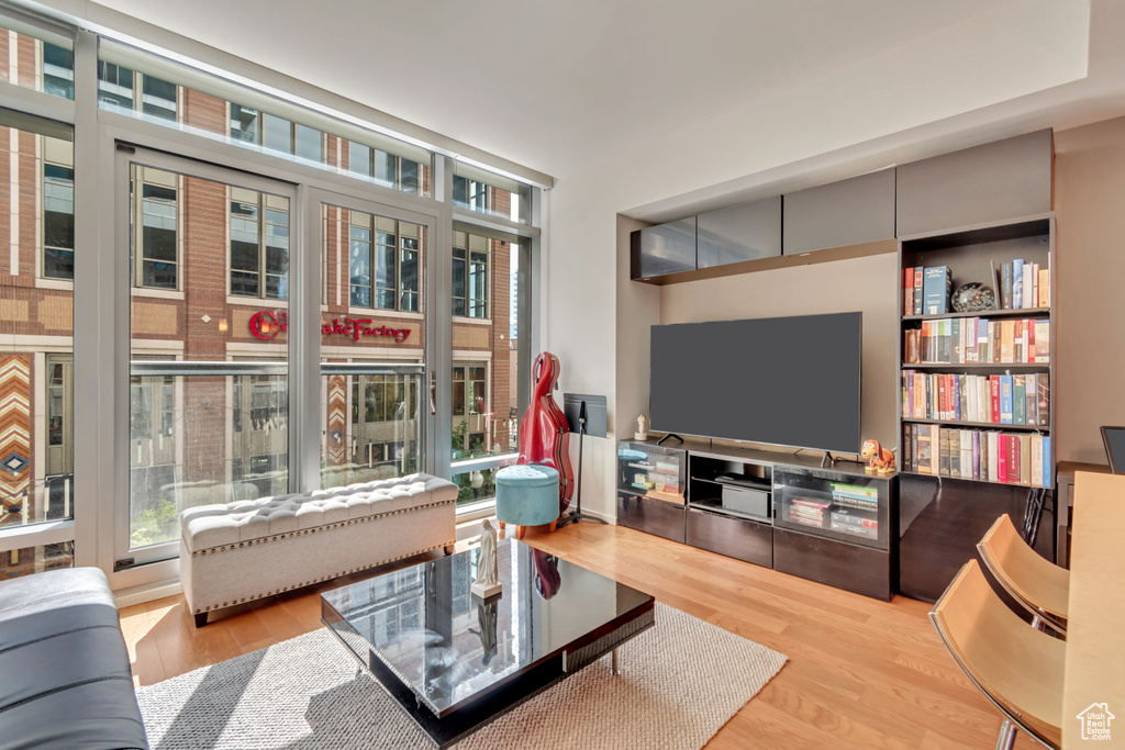Living area with a healthy amount of sunlight and wood finished floors