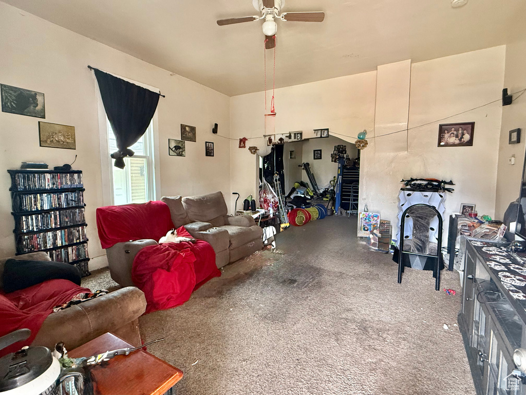 Carpeted living room with ceiling fan