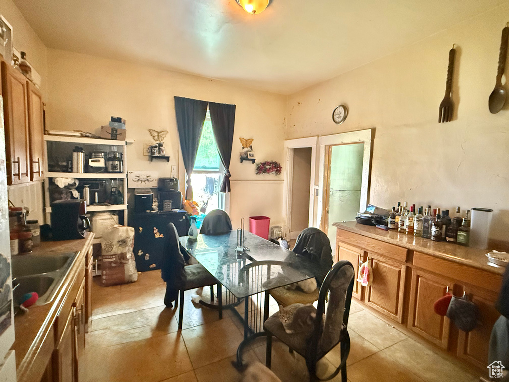 Dining space with light tile patterned floors