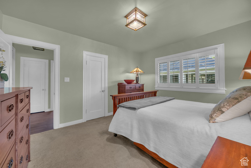 Bedroom with light carpet and baseboards