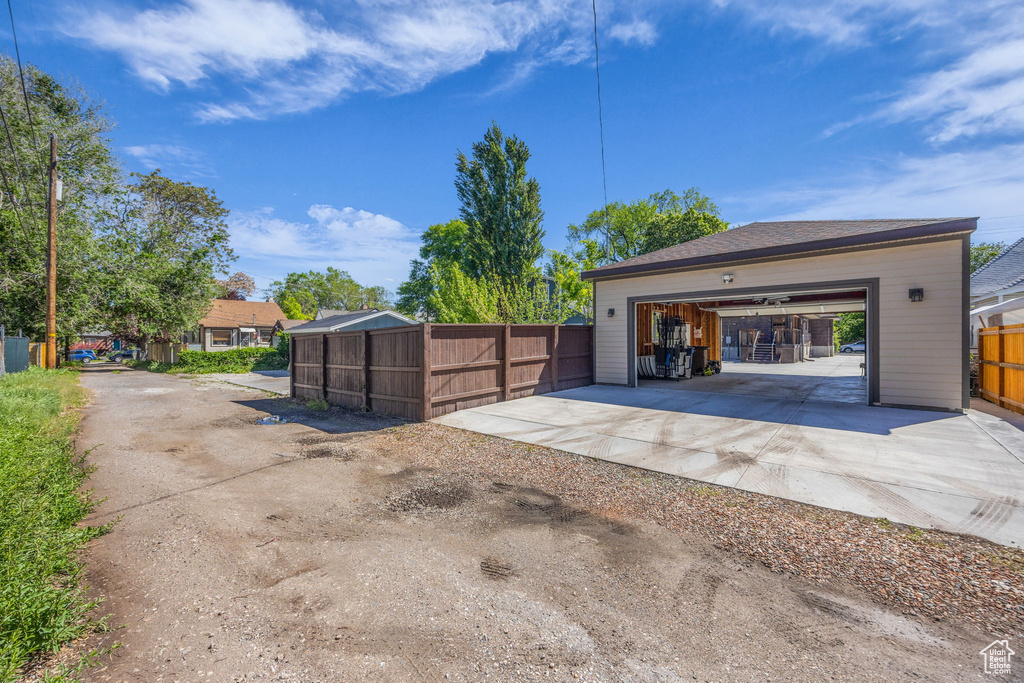 Detached garage featuring fence