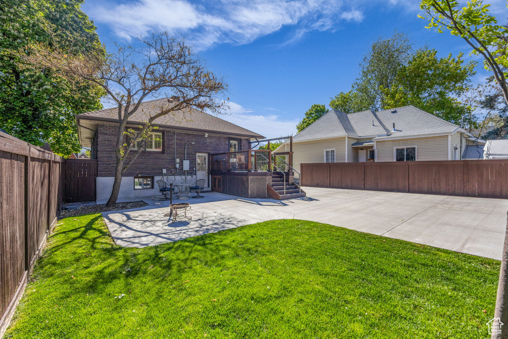 Rear view of property with a patio area, a covered hot tub, and a deck