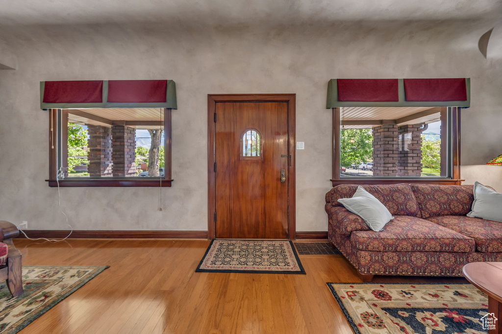 Entryway with hardwood / wood-style floors and baseboards