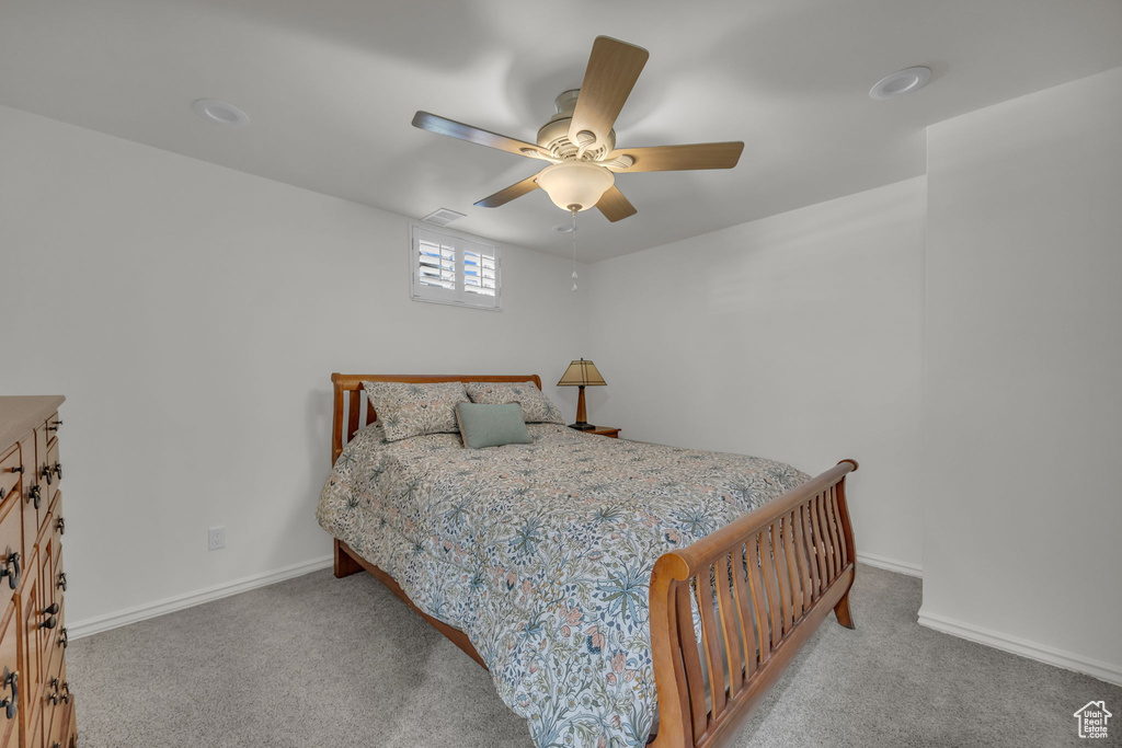 Bedroom with carpet, baseboards, and ceiling fan