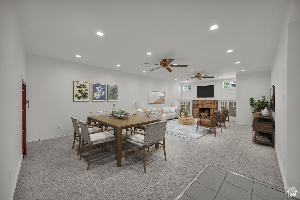 Dining space with recessed lighting, carpet, ceiling fan, a fireplace, and baseboards