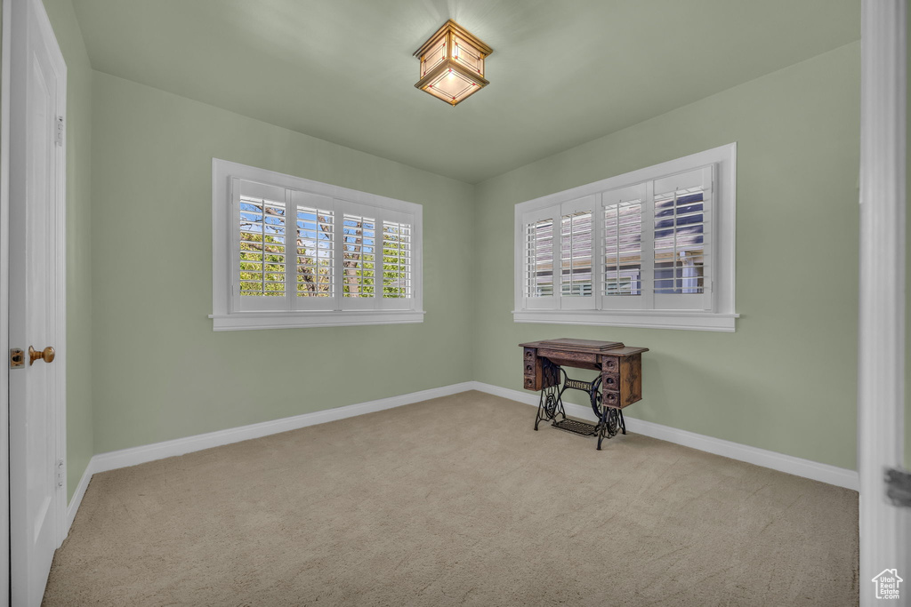 Carpeted empty room featuring baseboards