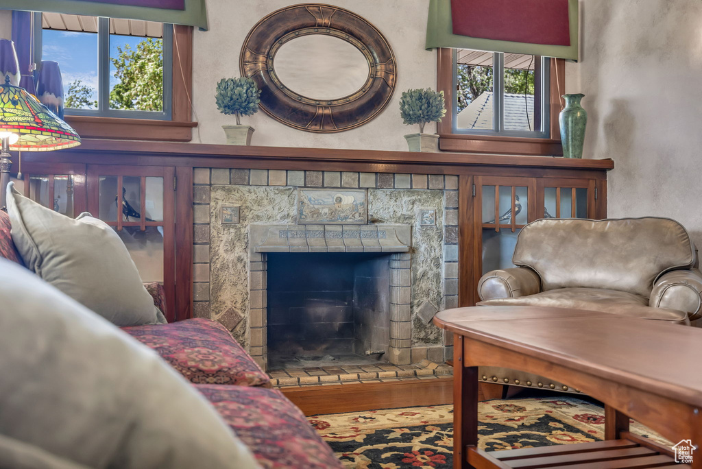 Sitting room featuring plenty of natural light and a fireplace