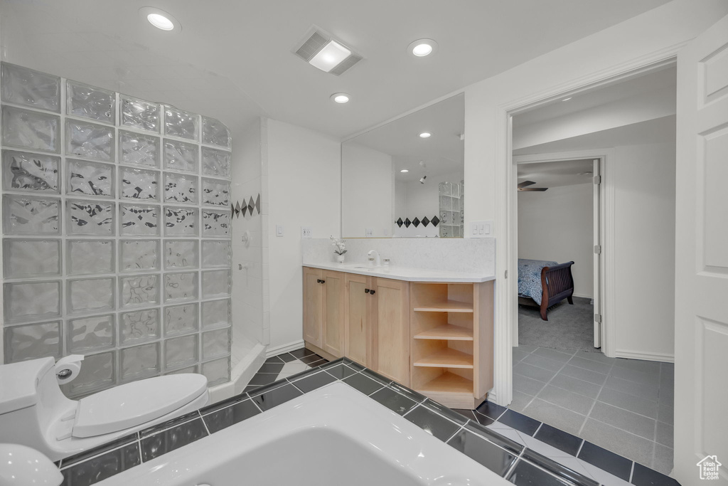 Ensuite bathroom with walk in shower, recessed lighting, baseboards, vanity, and tile patterned floors