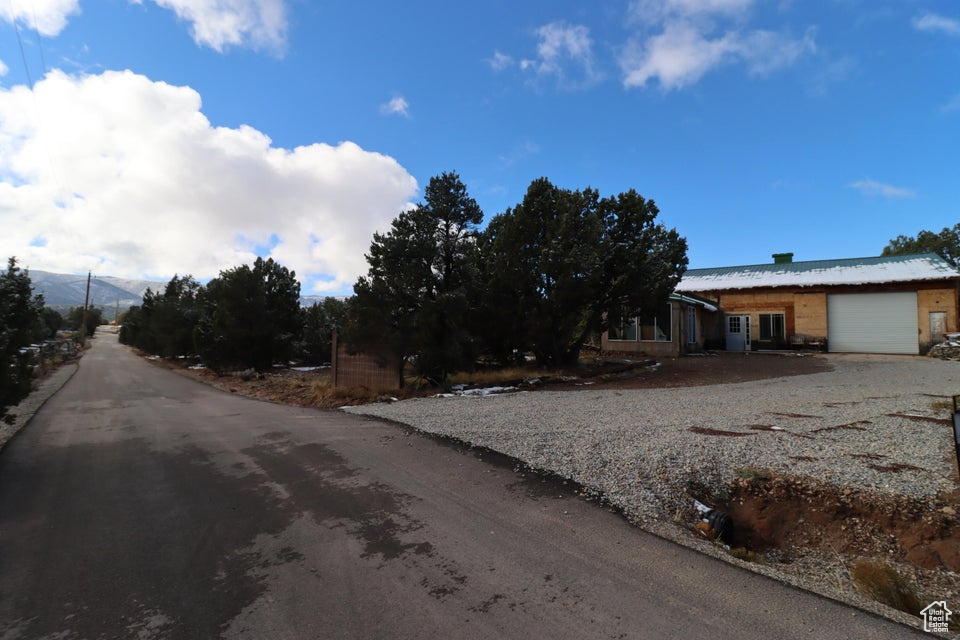 View of front of home featuring gravel driveway and an attached garage