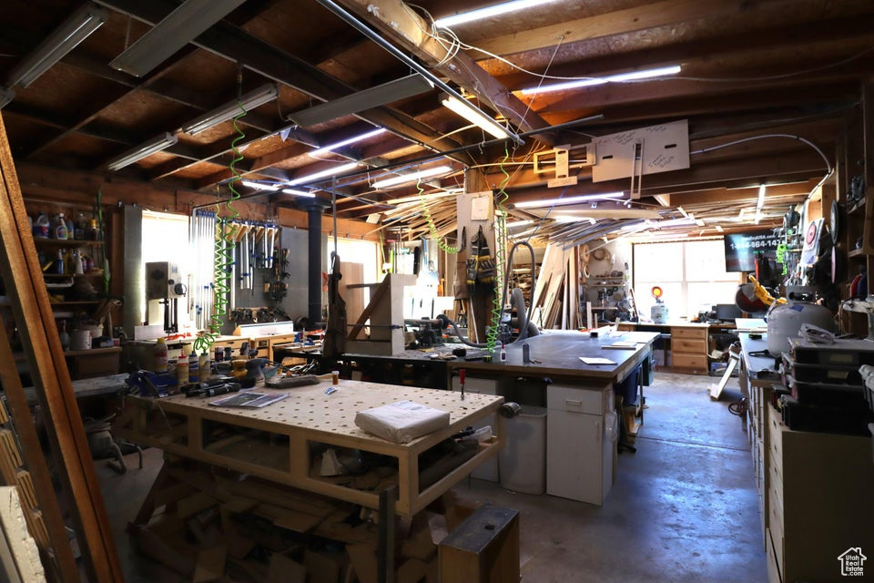 Misc room with concrete floors and a workshop area