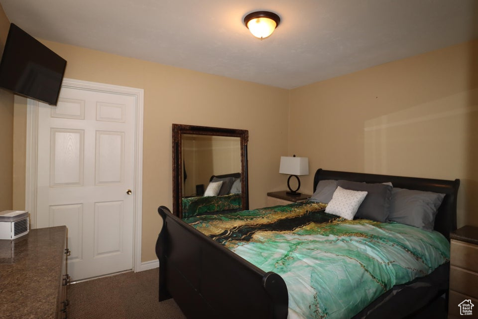 Bedroom featuring dark carpet
