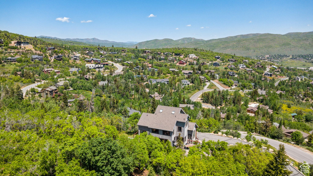 Aerial view of residential area featuring a mountainous background