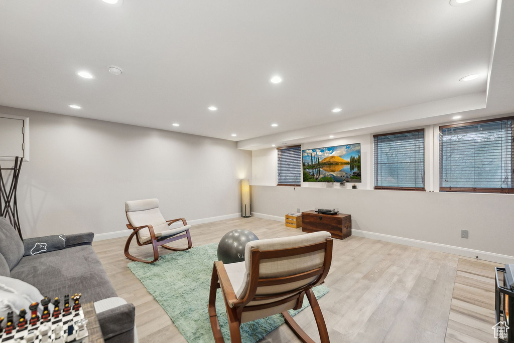 Living area featuring light wood-style floors, baseboards, and recessed lighting