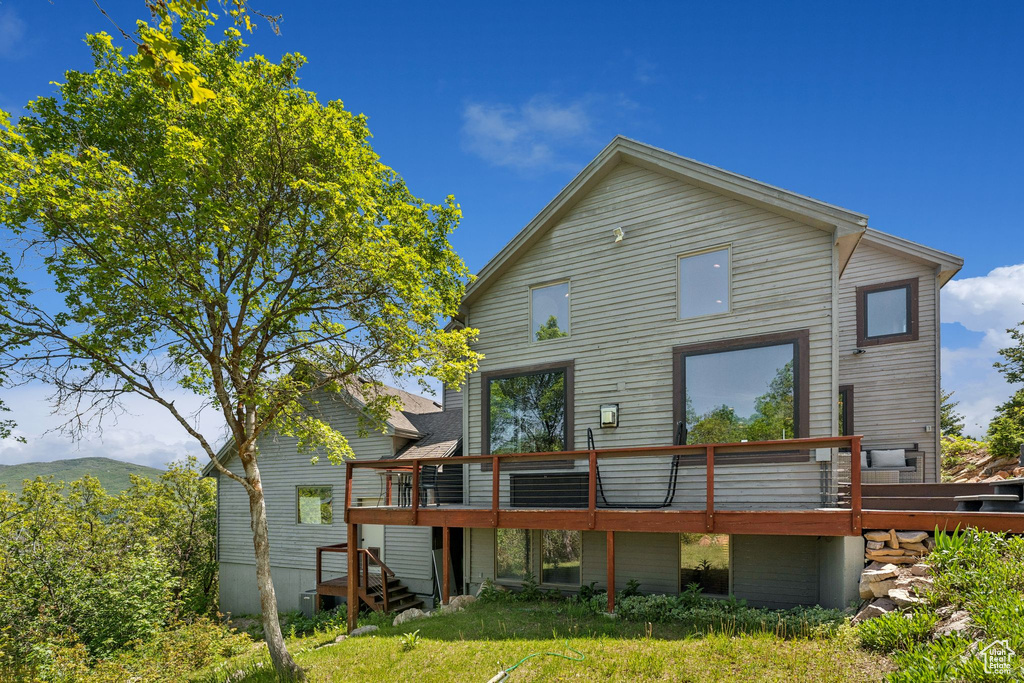 Rear view of property featuring a wooden deck