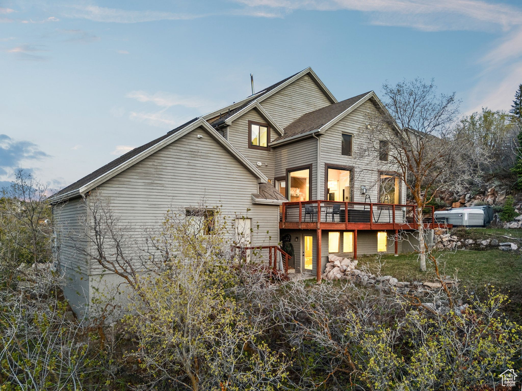 Rear view of property featuring a wooden deck