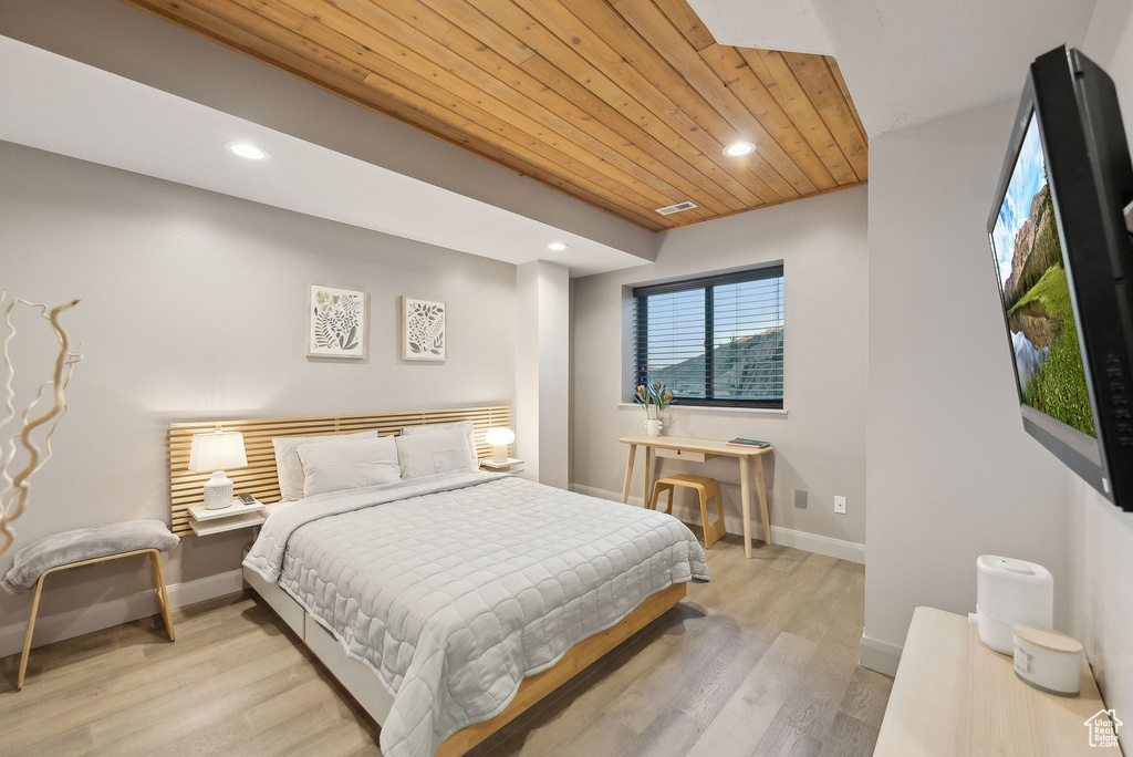 Bedroom with light wood finished floors, wood ceiling, visible vents, baseboards, and recessed lighting