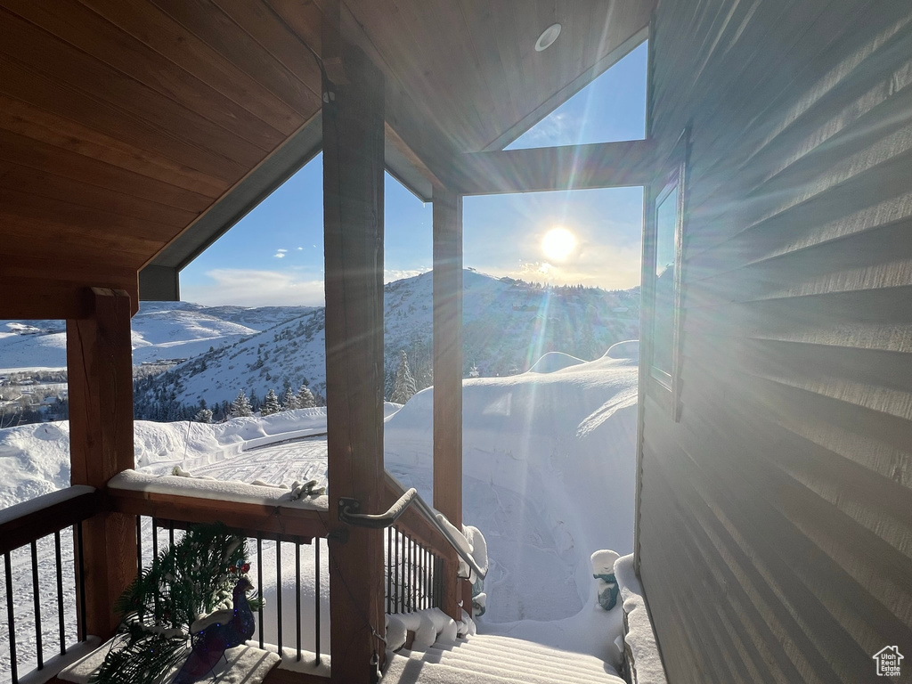 Snow covered deck with a mountain view
