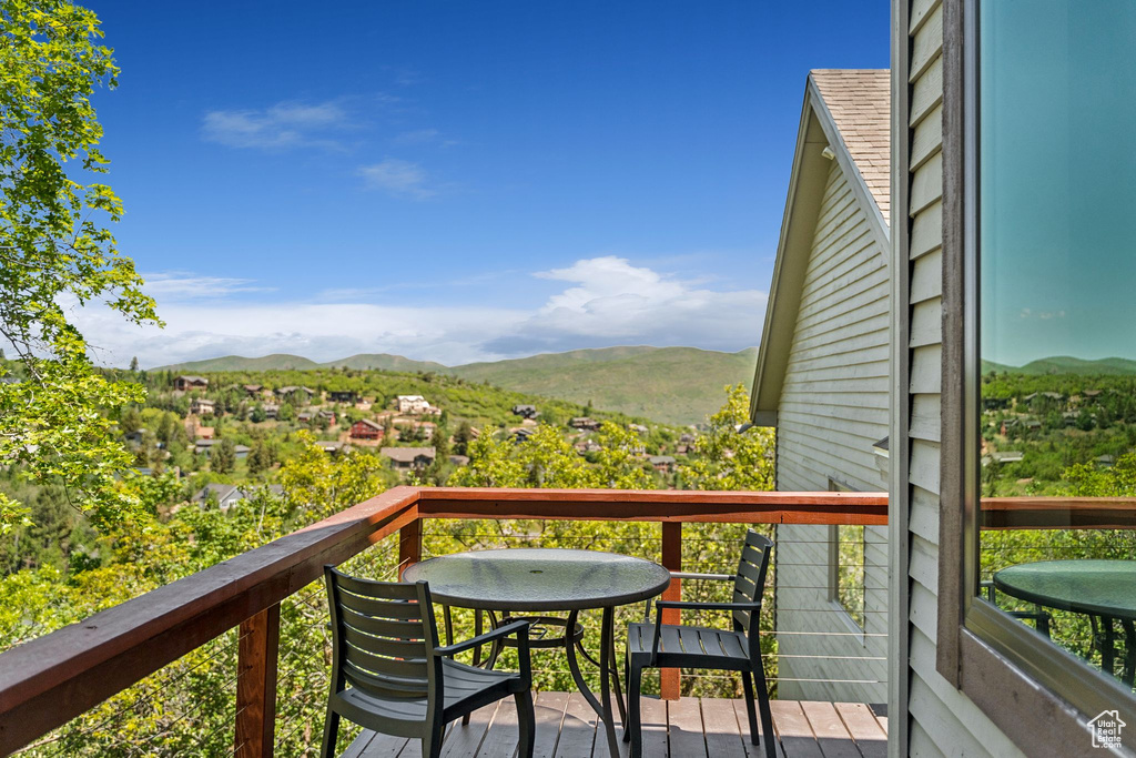 Balcony with a mountain view and outdoor dining space