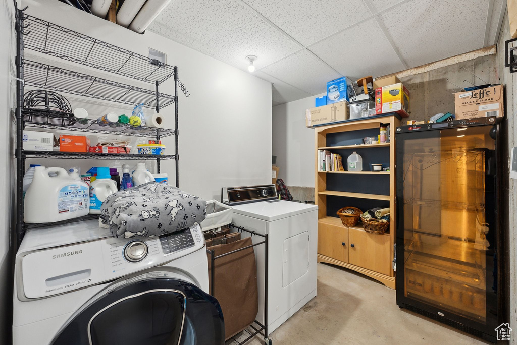 Clothes washing area featuring washer and clothes dryer and laundry area