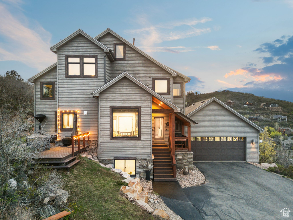 View of front of home with a wooden deck