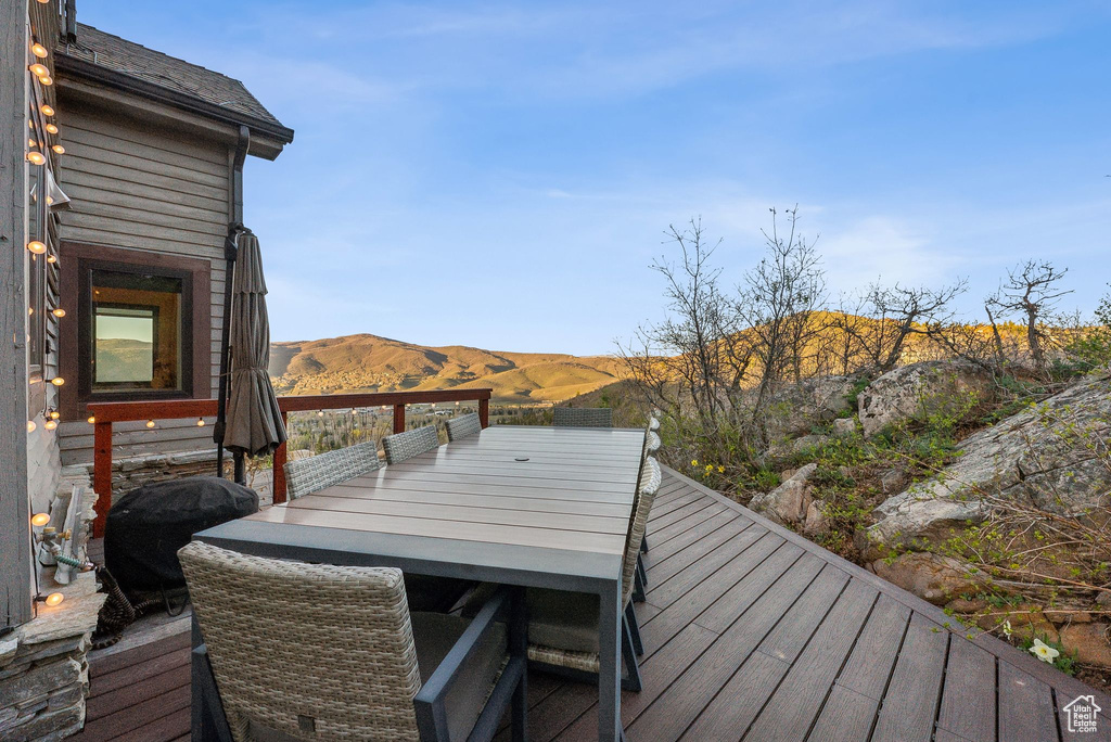 Deck featuring outdoor dining area and a mountain view