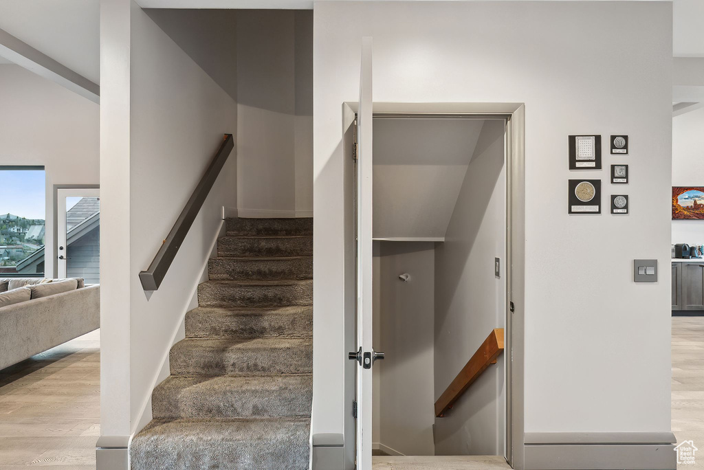 Stairs featuring baseboards and wood finished floors
