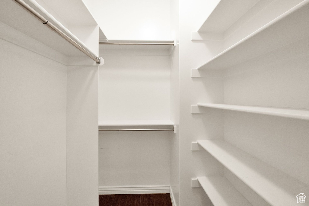 Walk in closet featuring wood finished floors
