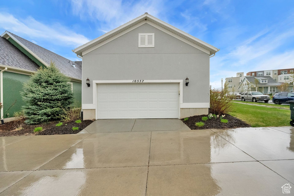 Exterior space with stucco siding and driveway