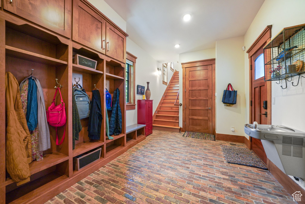 Mudroom with brick floor, baseboards, and recessed lighting