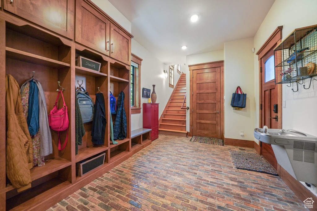 Mudroom featuring brick flooring and recessed lighting